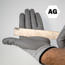 Picture of ANSI Cut Level 5 Gloves protecting a hand against a foreign piece of scrap metal